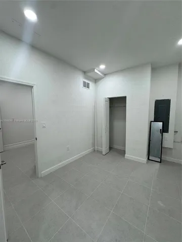 an empty room with furniture and closet