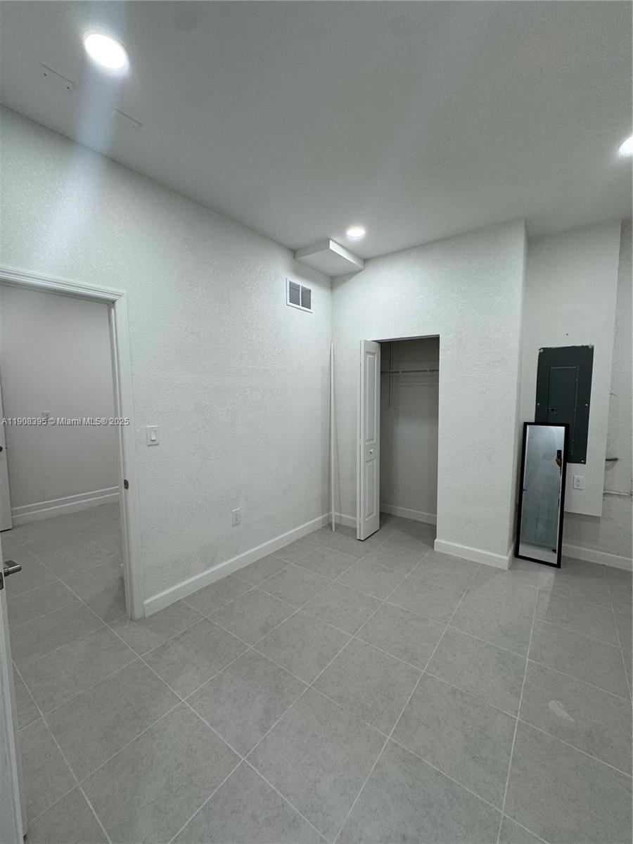 28850 Southwest 163rd Avenue, Unit 1 Homestead, FL 33033 - Photo 8 of 14 an empty room with furniture and closet