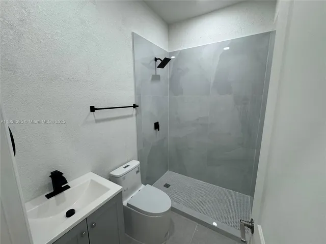 a bathroom with a shower and mirror