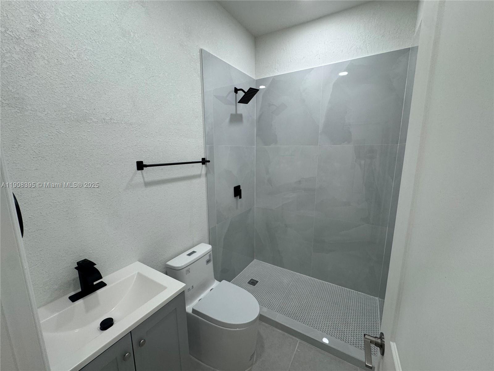 28850 Southwest 163rd Avenue, Unit 1 Homestead, FL 33033 - Photo 10 of 14 a bathroom with a shower and mirror