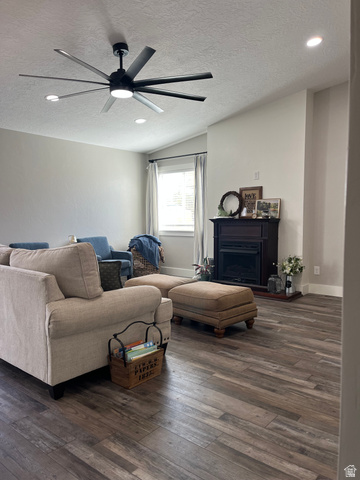 558 North N Cres Road Roosevelt, UT 84066 - Photo 8 of 31 Spacious living area featuring wood-finish flooring, a contemporary ceiling fan, recessed lighting, and a built-in fireplace with a dark wood mantle
