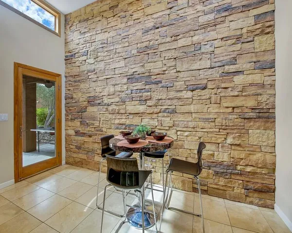 a bedroom with bed and glass windows