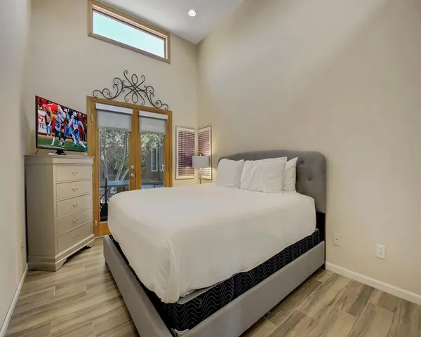 a bedroom with a bed and a chandelier