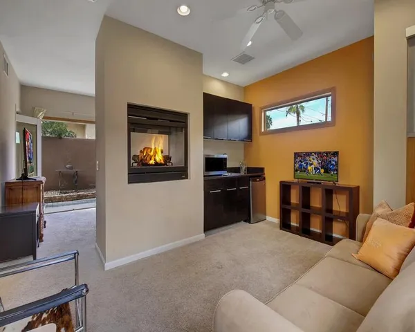 a bathroom with a granite countertop sink mirror vanity bathtub and a toilet