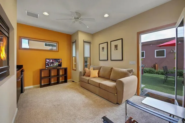 a building outdoor space with patio furniture and potted plants