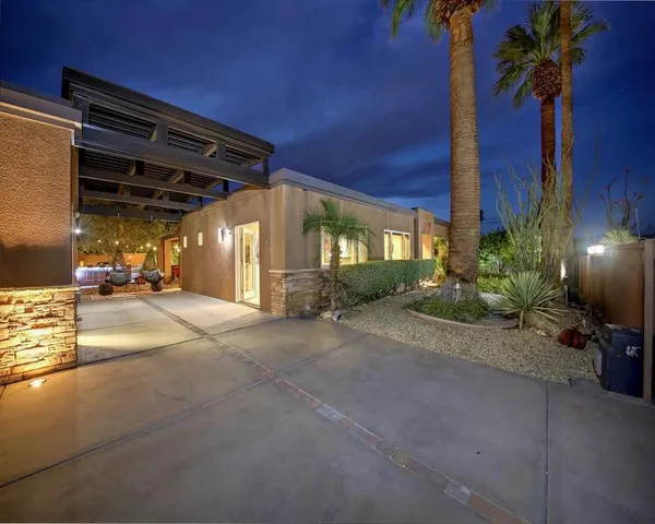 a view of a patio with a table and chairs