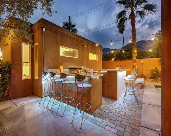 a view of a patio with a table and chairs