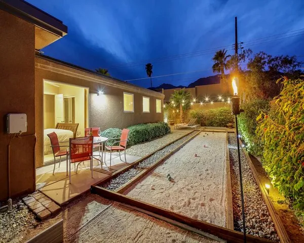 a view of a house with outdoor space and palm trees