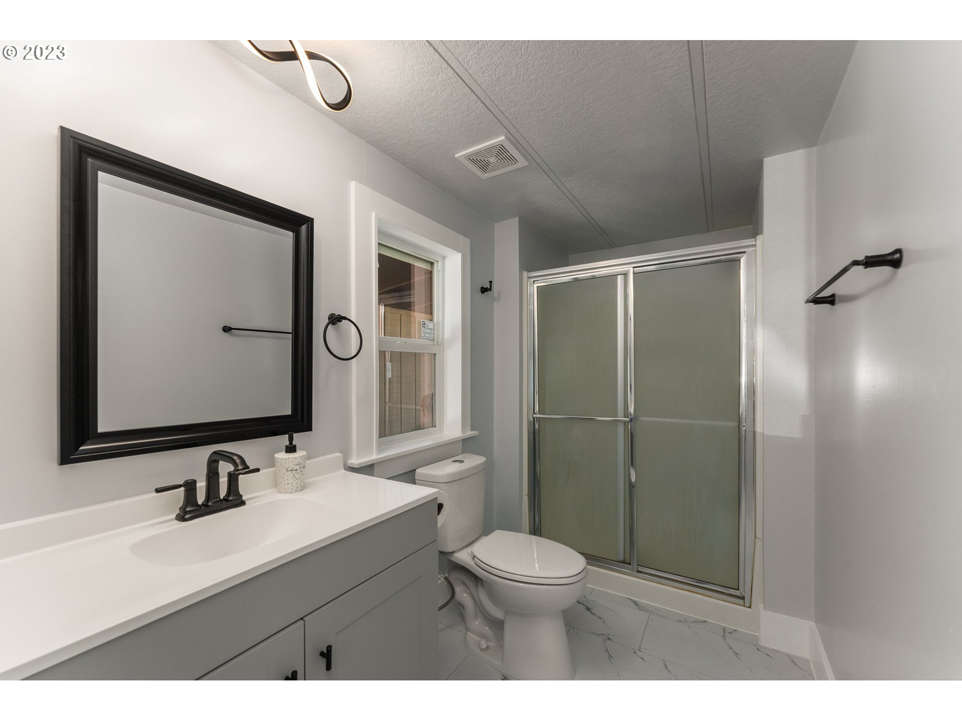 3130 U Street Springfield, OR 97477 - Photo 13 of 28 a bathroom with a sink toilet and shower