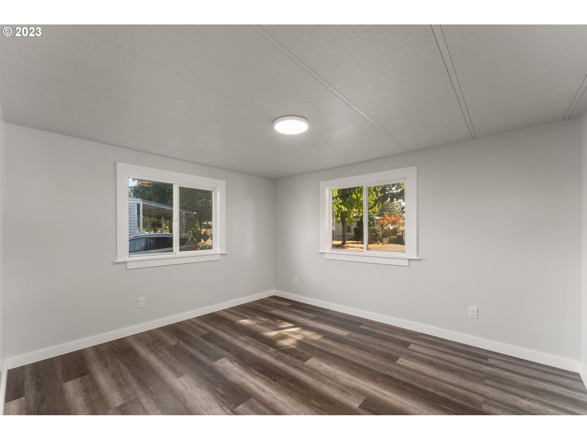 3130 U Street Springfield, OR 97477 - Photo 14 of 28 a view of an empty room with wooden floor and a window