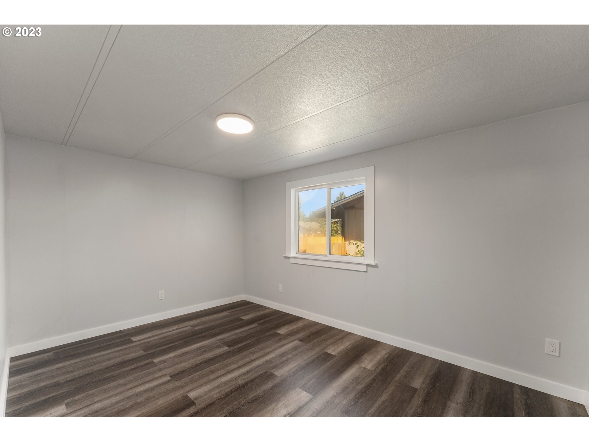 3130 U Street Springfield, OR 97477 - Photo 17 of 28 a view of an empty room with wooden floor and a window