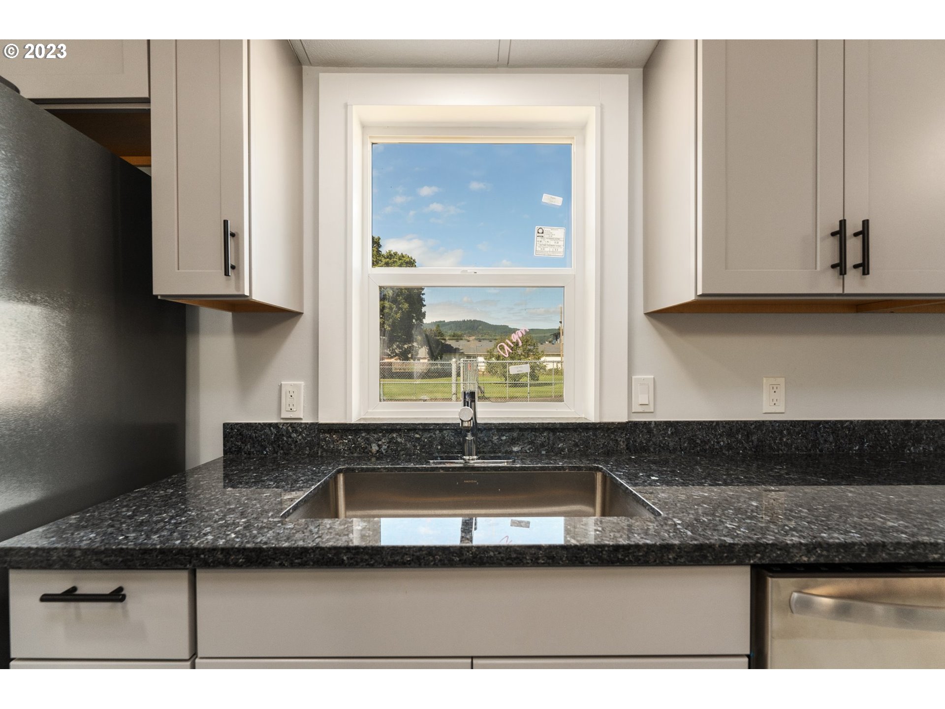 3130 U Street Springfield, OR 97477 - Photo 6 of 28 a kitchen with granite countertop a sink and cabinets