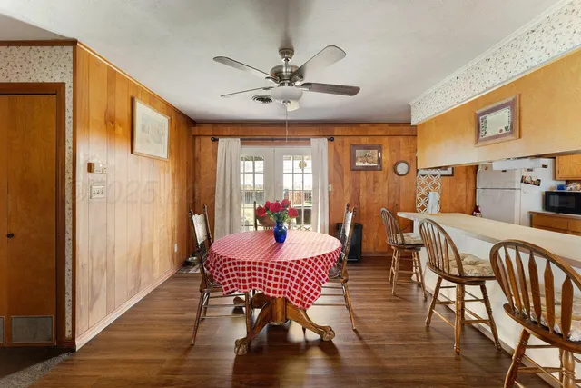 a dining room with furniture window and wooden floor