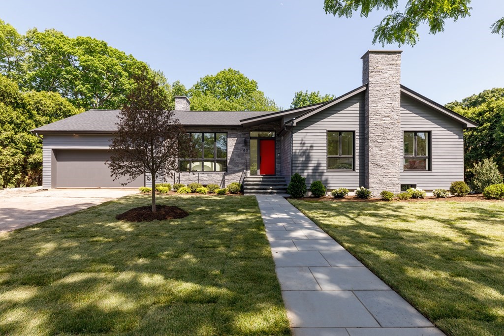 a front view of house with yard and green space