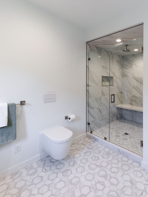 43 Ruane Road Newton, MA 02465 - Photo 11 of 24 a bathroom with a granite countertop sink a toilet and shower