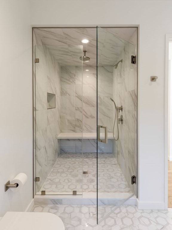 43 Ruane Road Newton, MA 02465 - Photo 12 of 24 a bathroom with a glass shower door