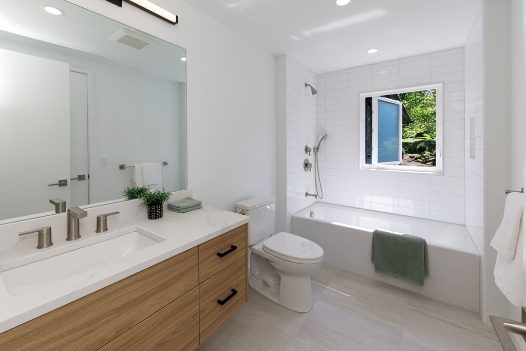 43 Ruane Road Newton, MA 02465 - Photo 14 of 24 a bathroom with a sink toilet a mirror and bathtub