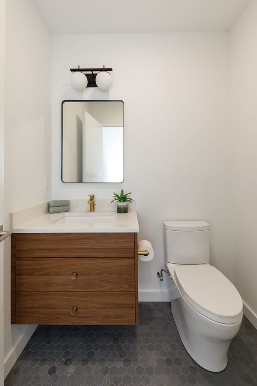 43 Ruane Road Newton, MA 02465 - Photo 15 of 24 a bathroom with a toilet a sink and mirror