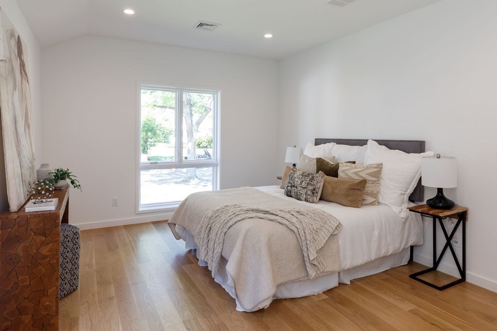43 Ruane Road Newton, MA 02465 - Photo 17 of 24 a bedroom with a bed and a wooden floor