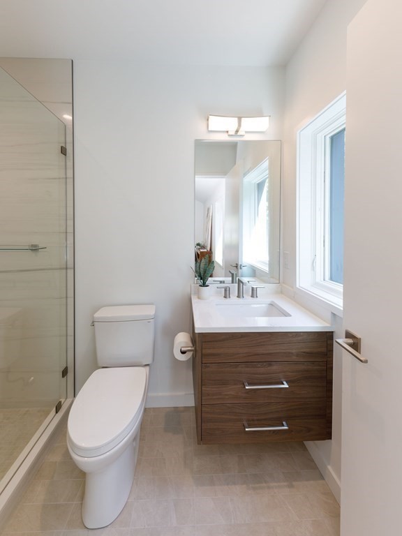 43 Ruane Road Newton, MA 02465 - Photo 18 of 24 a bathroom with a sink a toilet and mirror