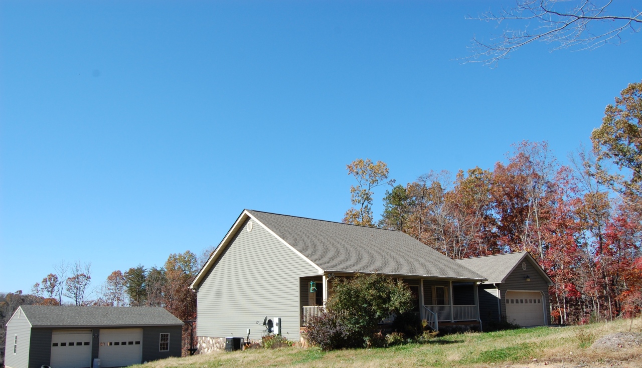 2057 Morgans Mill Road Goodview, VA 24095 - Photo 1 of 18 a view of a white house with a yard