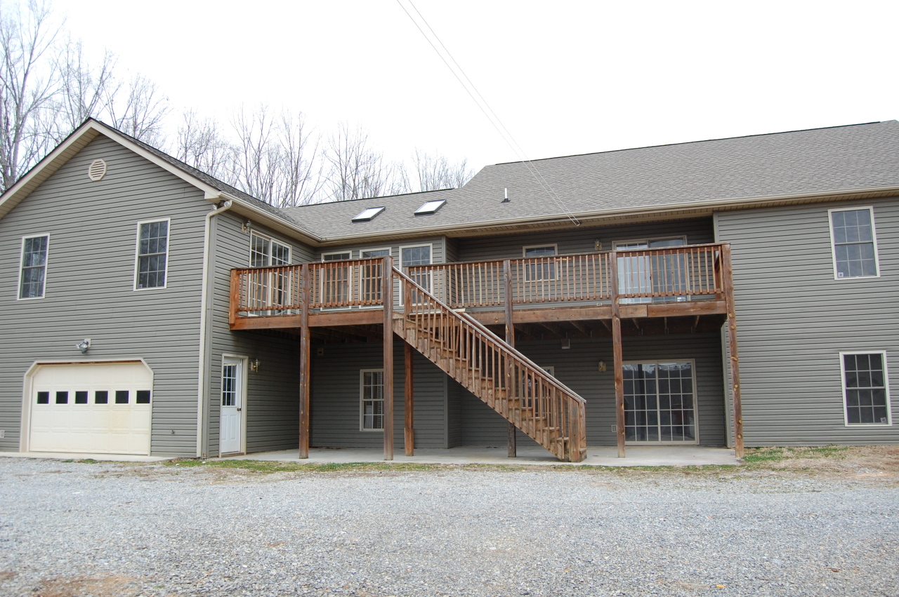 2057 Morgans Mill Road Goodview, VA 24095 - Photo 2 of 18 a front view of a house with a garage