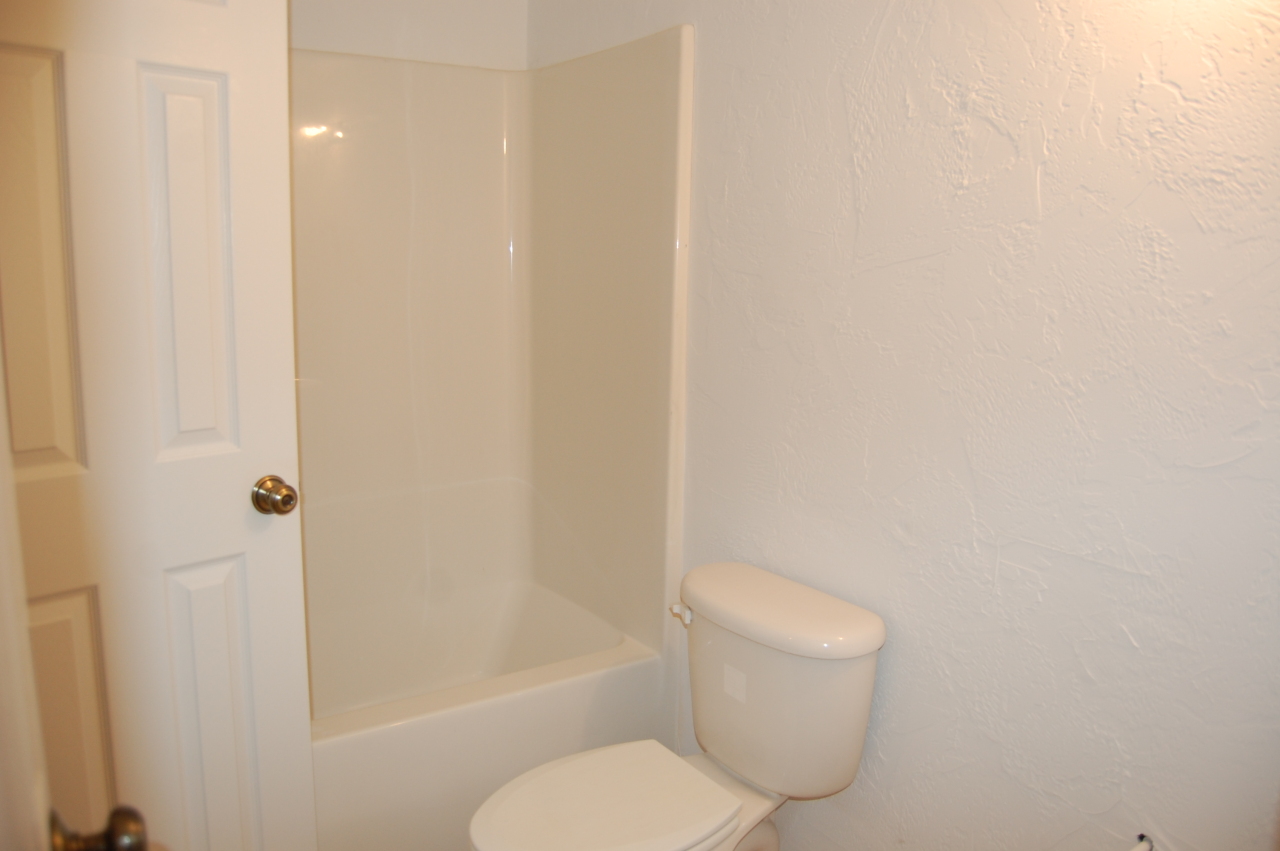 2057 Morgans Mill Road Goodview, VA 24095 - Photo 15 of 18 a white toilet sitting next to a bath tub