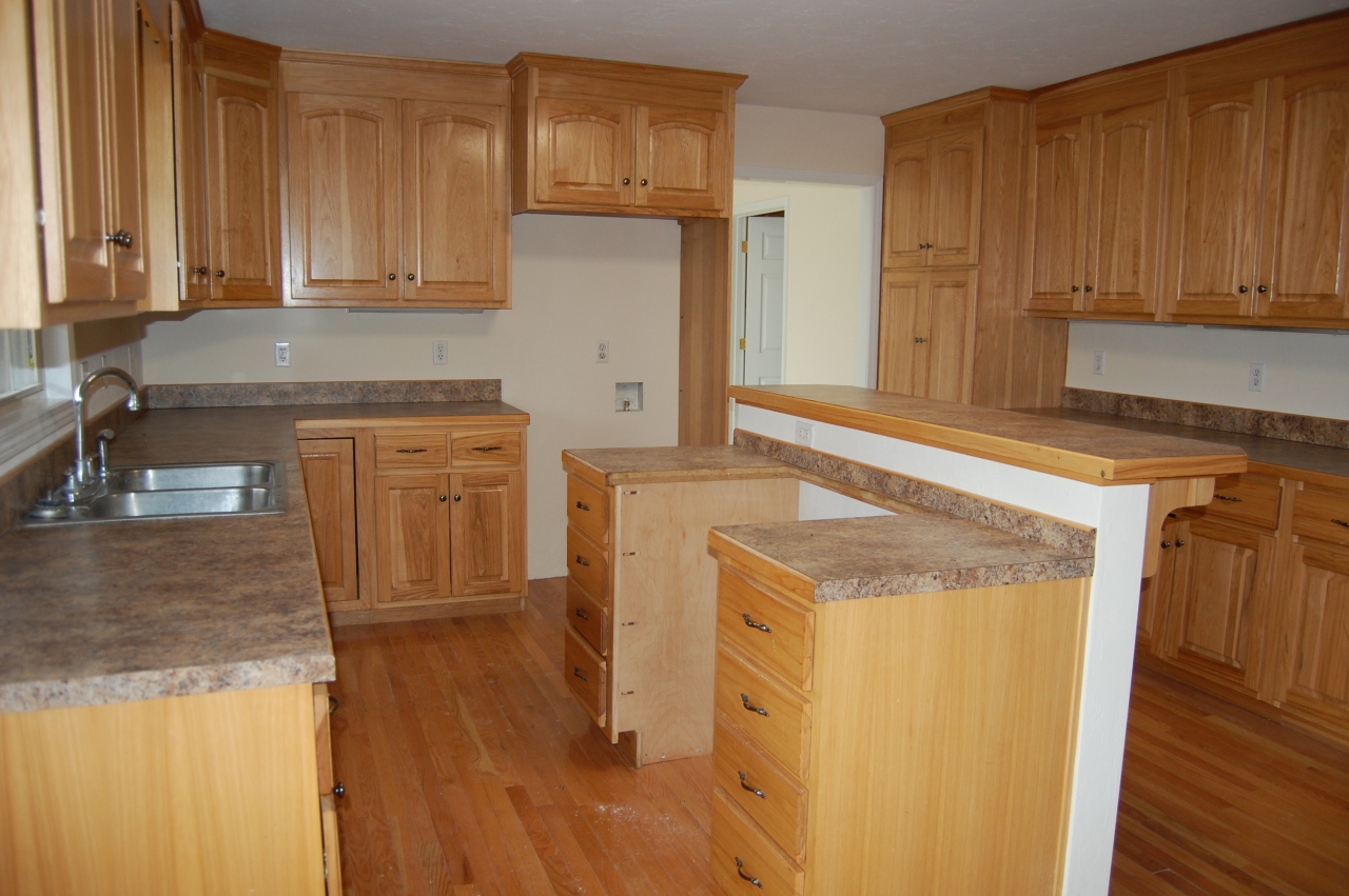 2057 Morgans Mill Road Goodview, VA 24095 - Photo 3 of 18 a kitchen with stainless steel appliances granite countertop wooden cabinets a sink and a stove