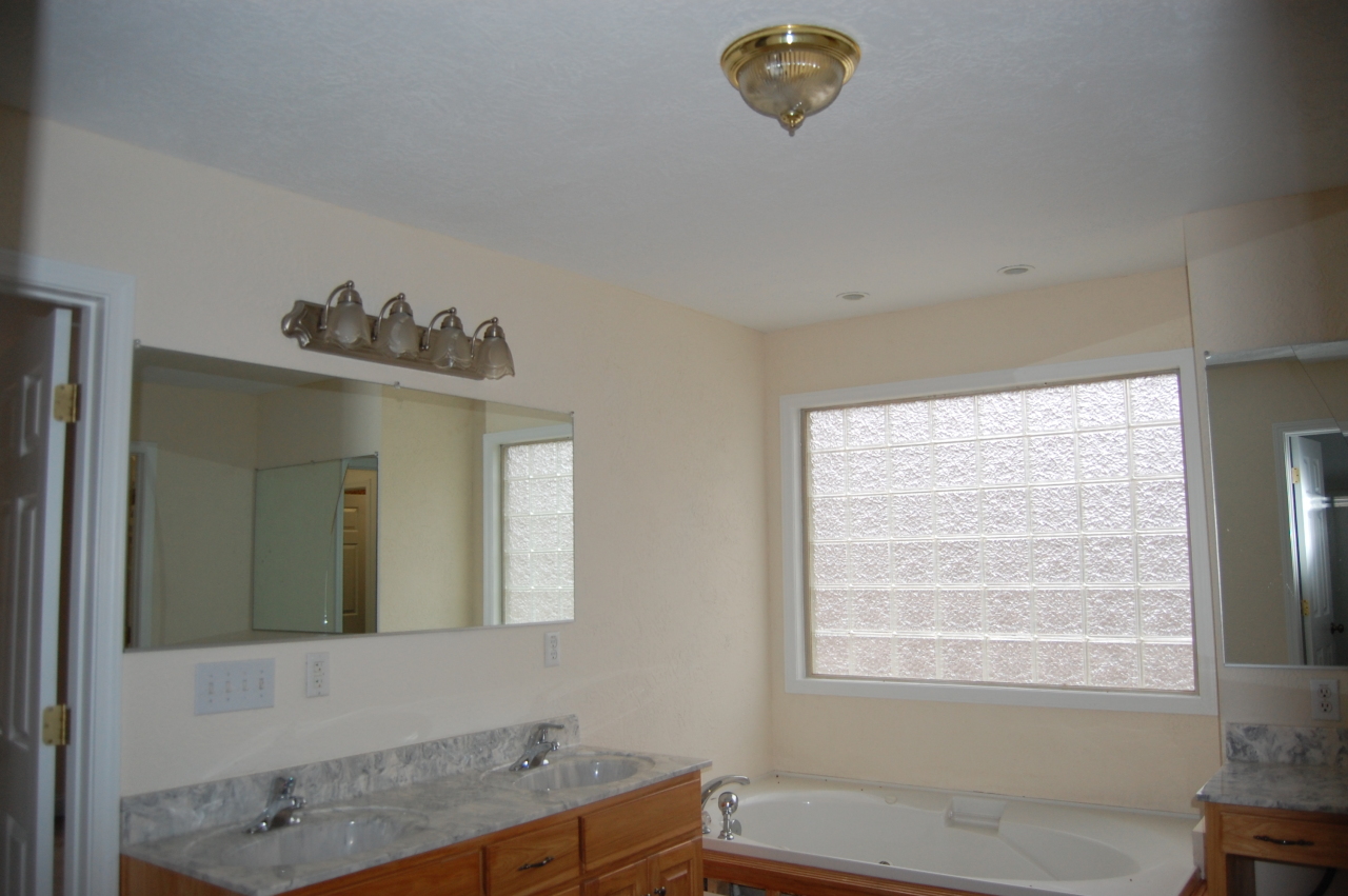 2057 Morgans Mill Road Goodview, VA 24095 - Photo 7 of 18 a bathroom with a sink a mirror and a bathtub