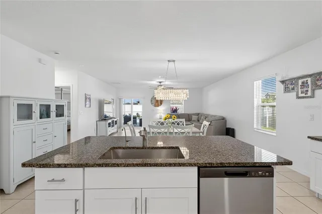 a view of a dining room with furniture and chandelier