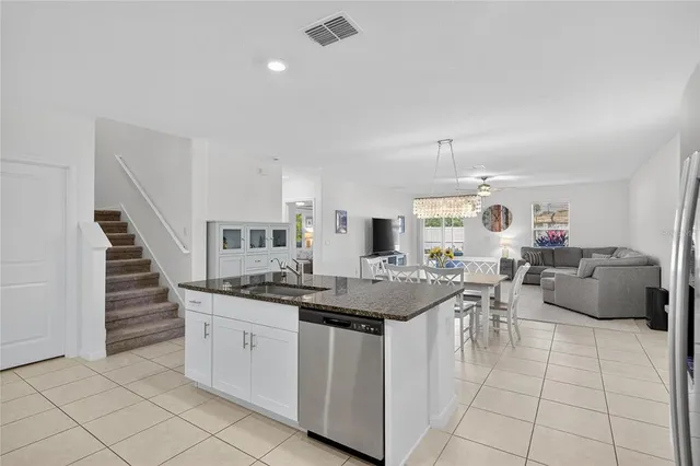 a living room with furniture and kitchen view