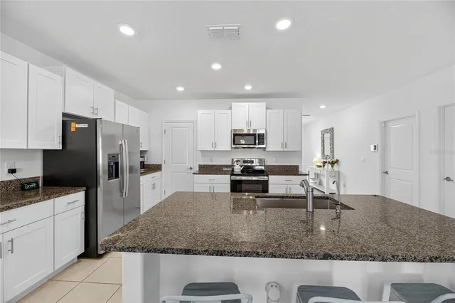 a bedroom with a large bed and a chandelier