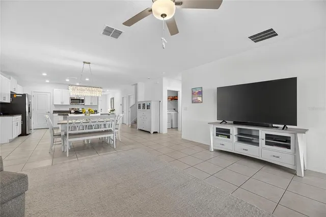 a bedroom with a bed and a ceiling fan