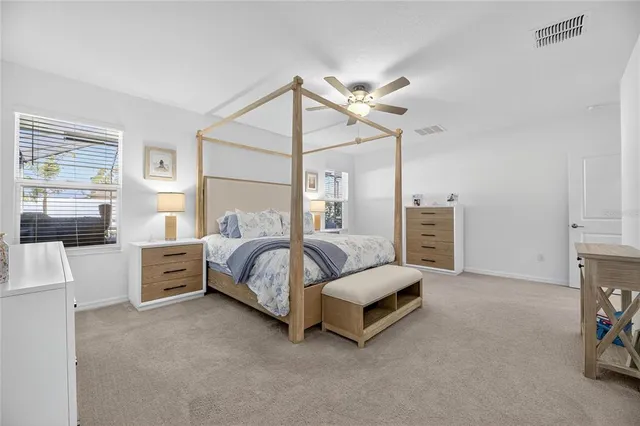 a bedroom with a bed and a ceiling fan