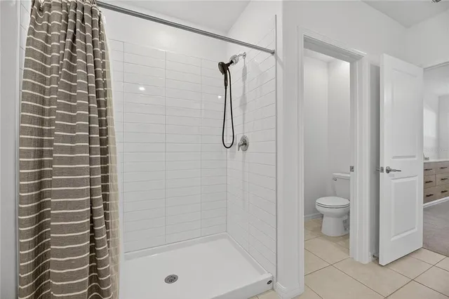 a bedroom with a large bed and a fireplace