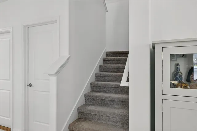 a view of a patio with a table and chairs under an umbrella