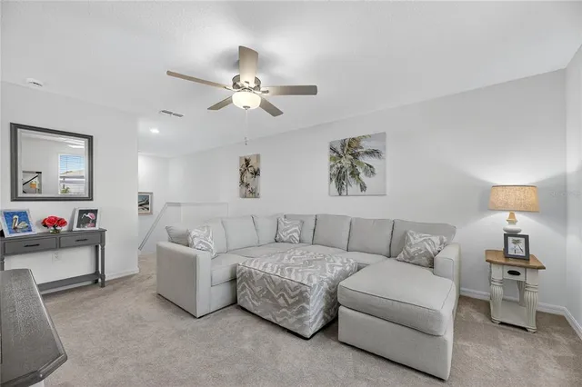 a living room with fireplace furniture and a large window