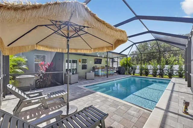 a kitchen with granite countertop a sink and a refrigerator