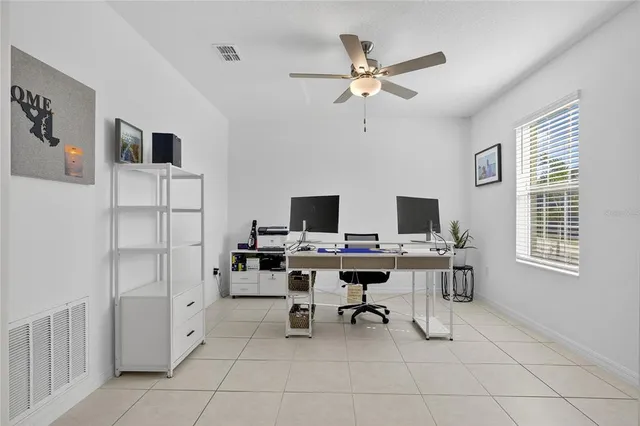 a kitchen with granite countertop white cabinets and stainless steel appliances
