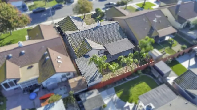 an aerial view of a house a yard and outdoor seating