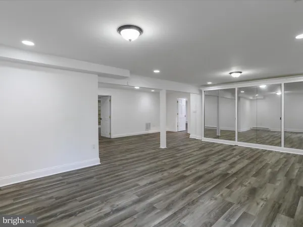 a large kitchen with kitchen island granite countertop a large counter top cabinets and stainless steel appliances