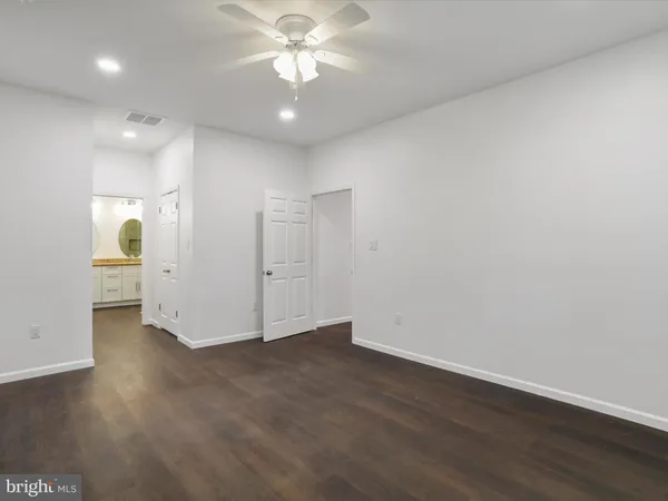 a bathroom with a double vanity sink toilet and shower
