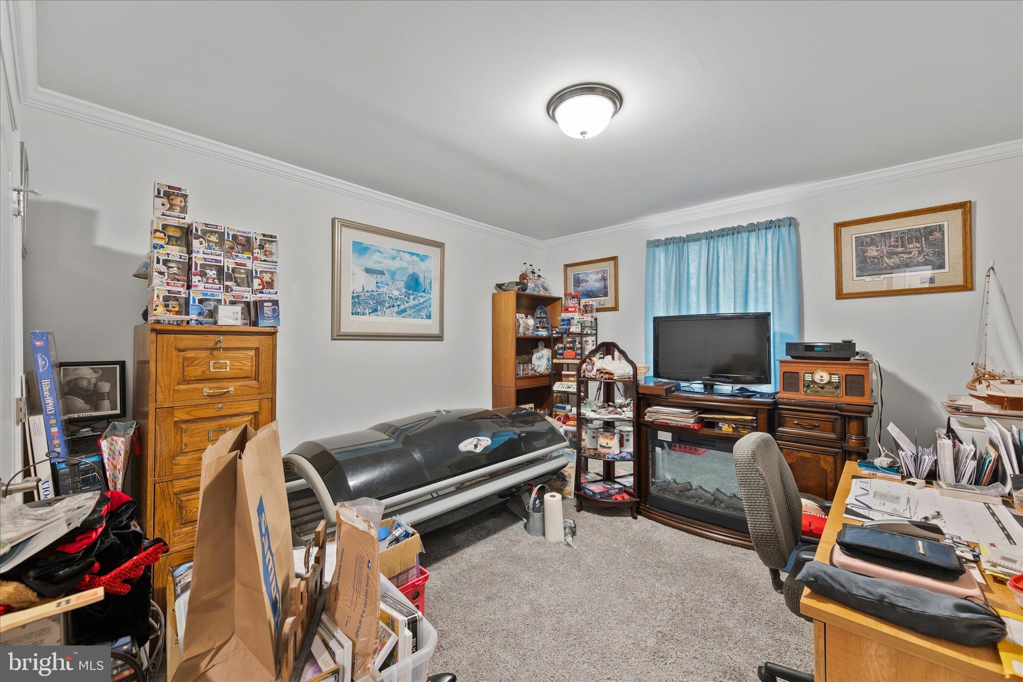 21933 Conrail Road Seaford, DE 19973 - Photo 14 of 35 a room with furniture a flat screen tv and a window