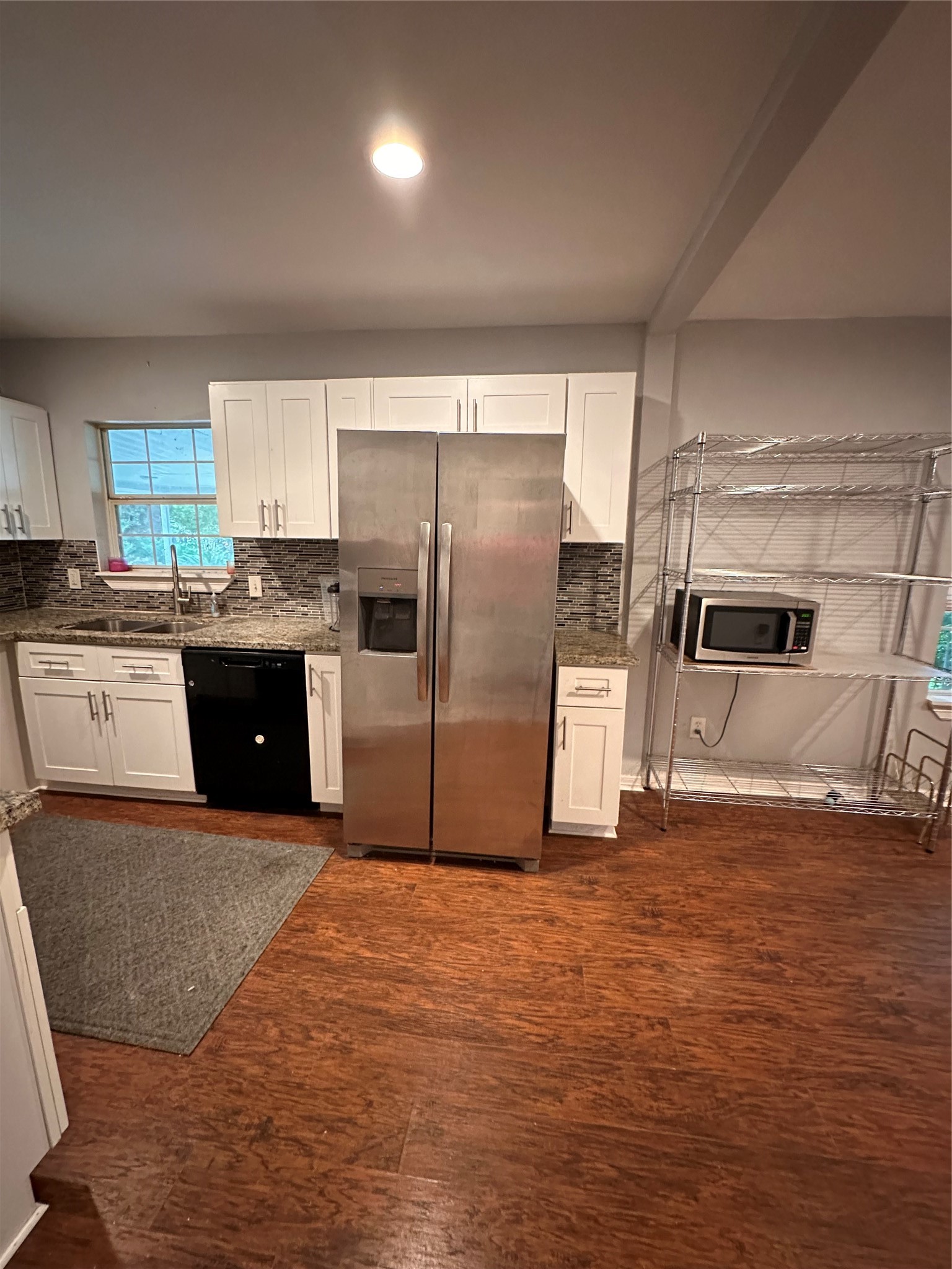 4802 Eppes Street Houston, TX 77021 - Photo 8 of 34 a kitchen with stainless steel appliances a refrigerator and a stove top oven