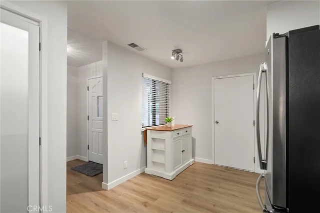 a view of a kitchen with dishwasher and a refrigerator