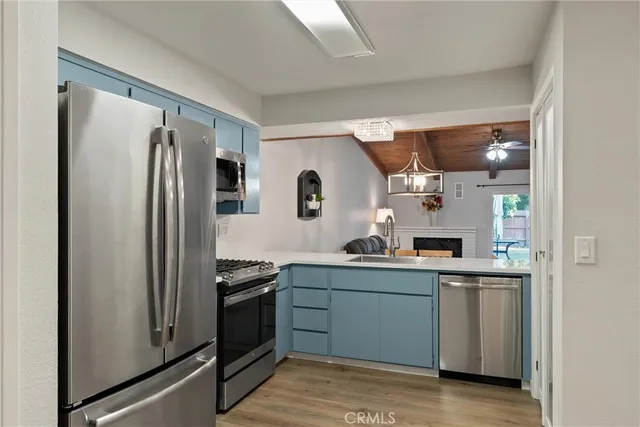 a kitchen with stainless steel appliances granite countertop a refrigerator and a sink
