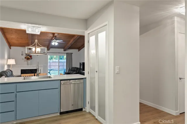 a kitchen with a sink a window and stainless steel appliances