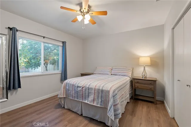 a bedroom with a bed a chandelier and a window