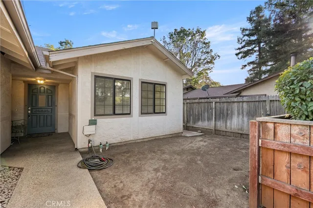 a view of backyard with deck and outdoor seating
