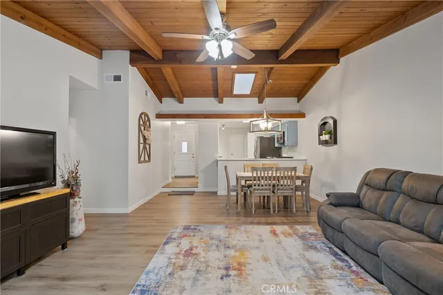 a dining room with furniture and wooden floor